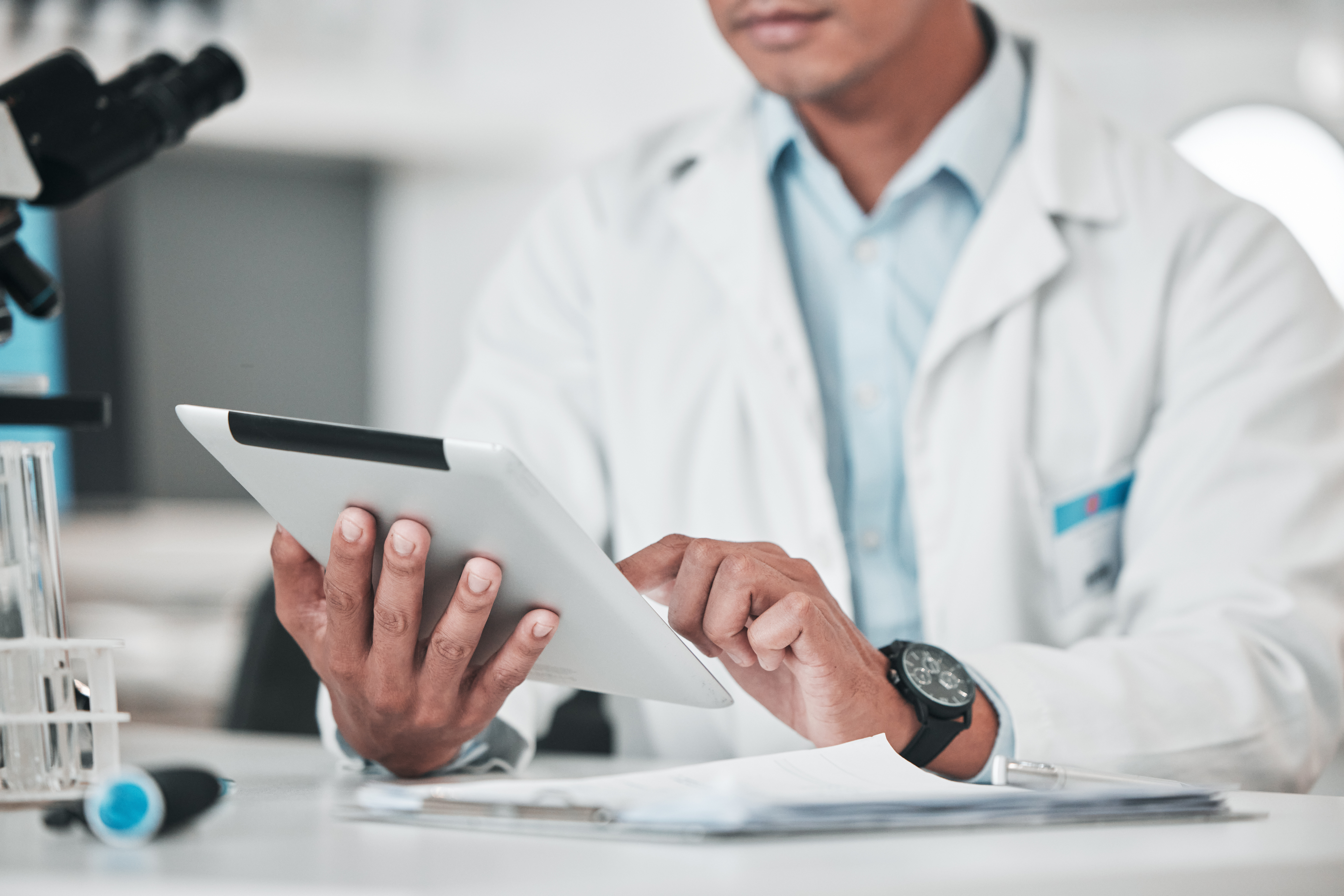 Man, hands and tablet in science laboratory for chemistry development, research and medical software for investigation. Closeup of scientist, digital analysis and test for biotechnology report online.